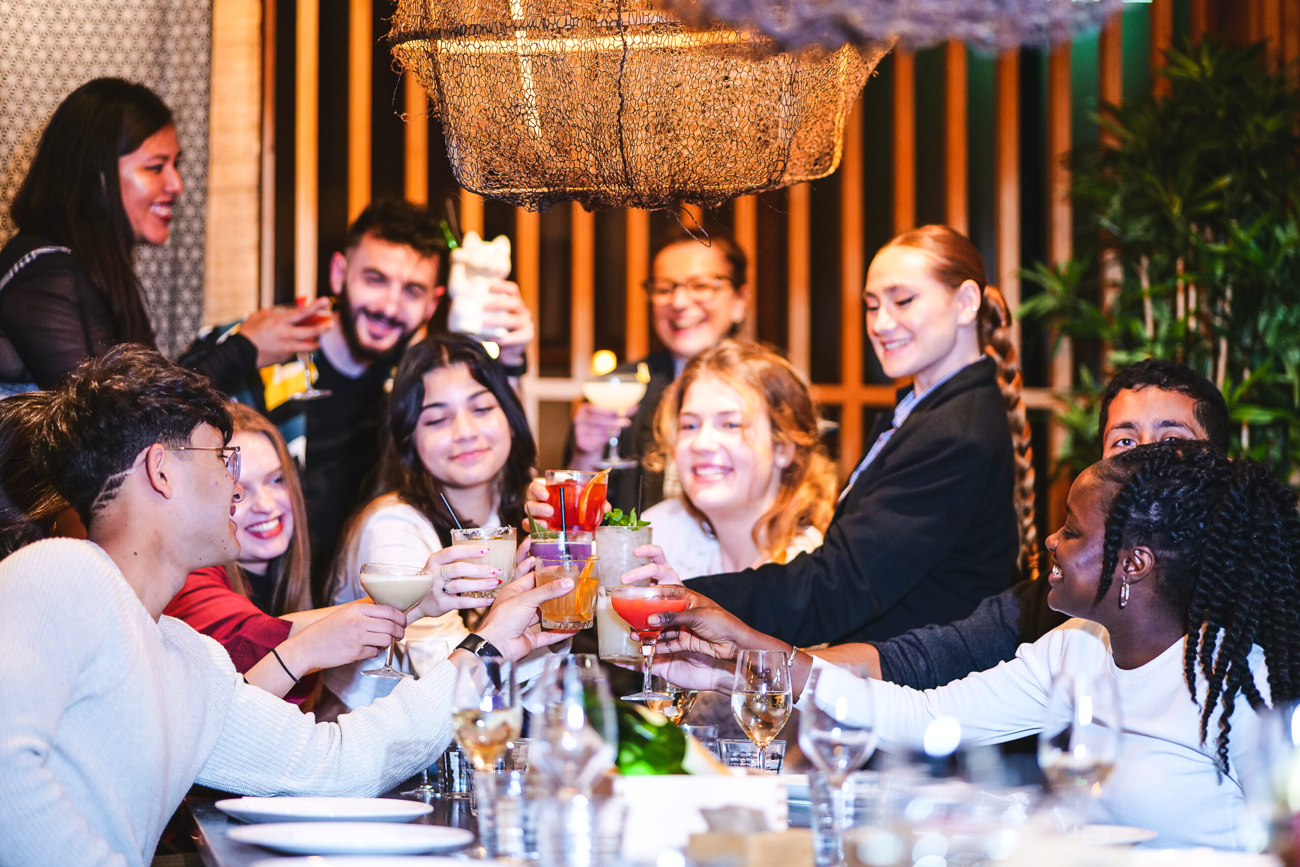 A group sharing cocktails at Flesh & Buns